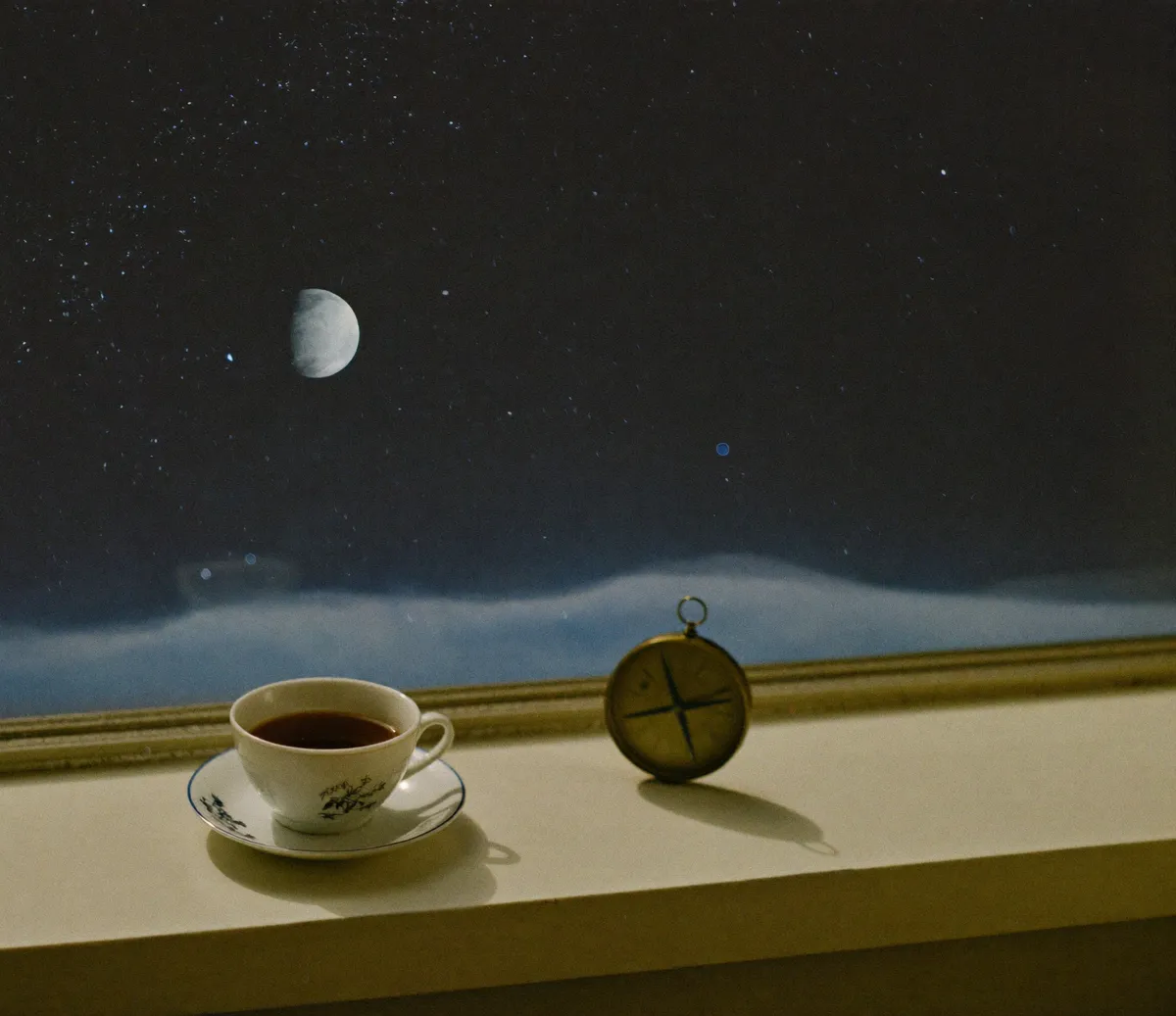 A woman reading her printed birth chart at a kitchen table, natal chart wheel and a notebook beside her coffee