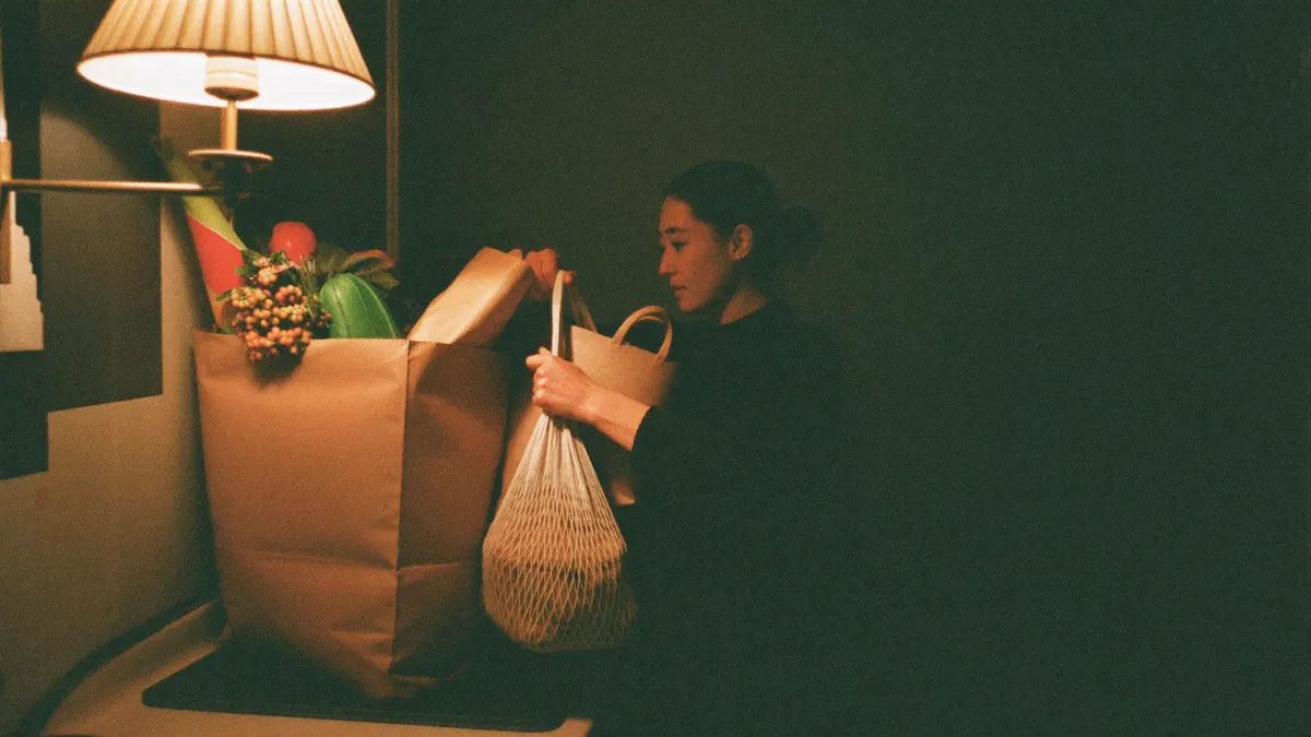 A woman carrying several bags alone up a stairwell, refusing offered help · what hyper independence looks like day to day