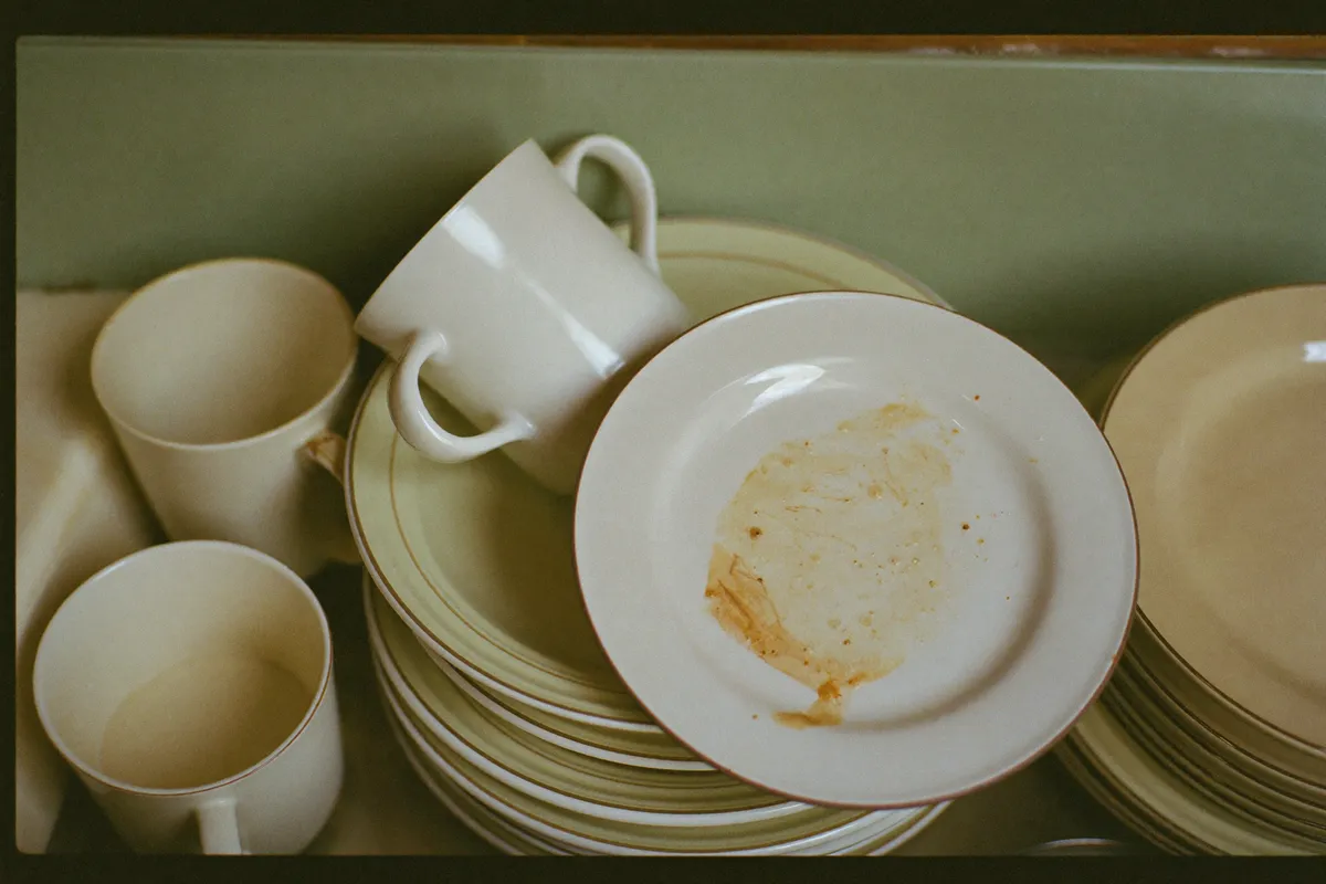 A woman in her forties alone at the kitchen sink after everyone else has gone to bed, the quiet cost of life path number 6